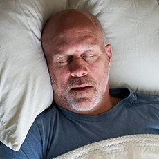 Man sleeping soundly in bed