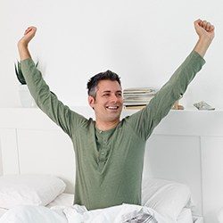 Happy man waking up feeling refreshed