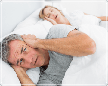 man who can't sleep because woman is snoring