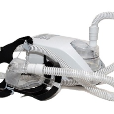 Gray and black CPAP machine isolated against plain white background