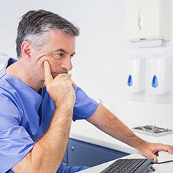 Dentist reviewing results of pharyngometry test on computer