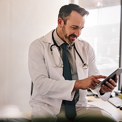 Doctor using electronic tablet to analyze test results