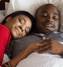 Man and woman sleeping in bed