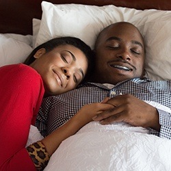 Man and woman sleeping in bed