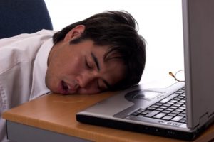 man asleep at desk mouth open