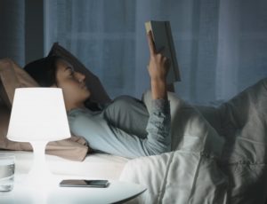 woman smiling reading a book