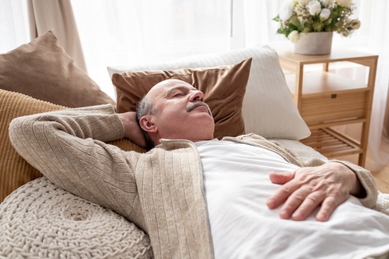 Man laying on his couch and napping 