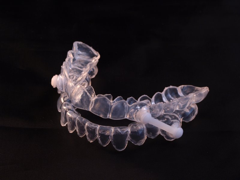 sleep apnea oral appliance on black background