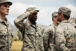 Military personal with one man giving salute