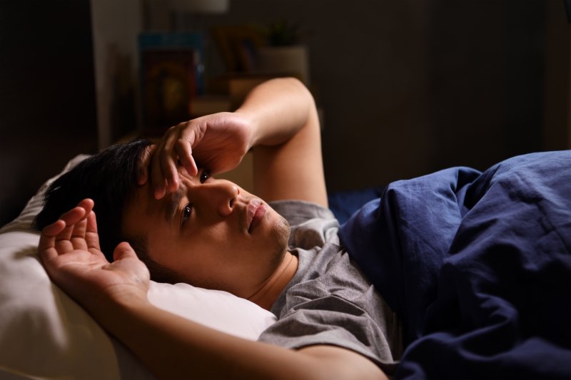 young man having sleep apnea nightmare
