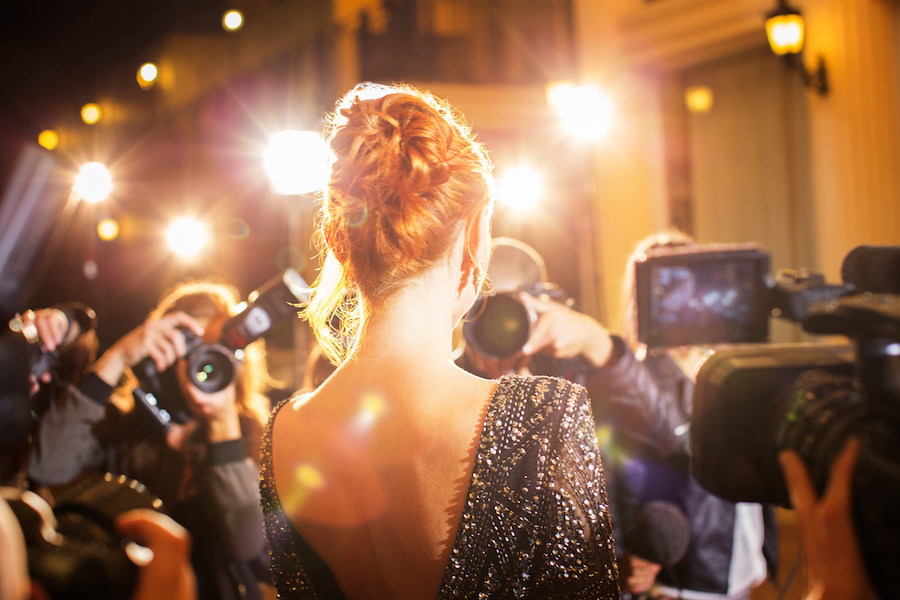 celebrity being photographed on red carpet