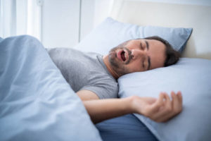 Man sleeping on his back snoring