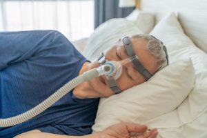 Man sleeping while using CPAP machine