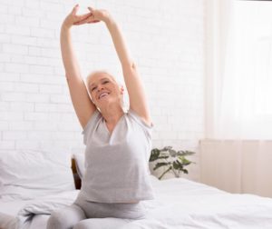 older woman waking up feeling refreshed 