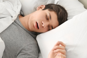 Young man in grey shirt snoring